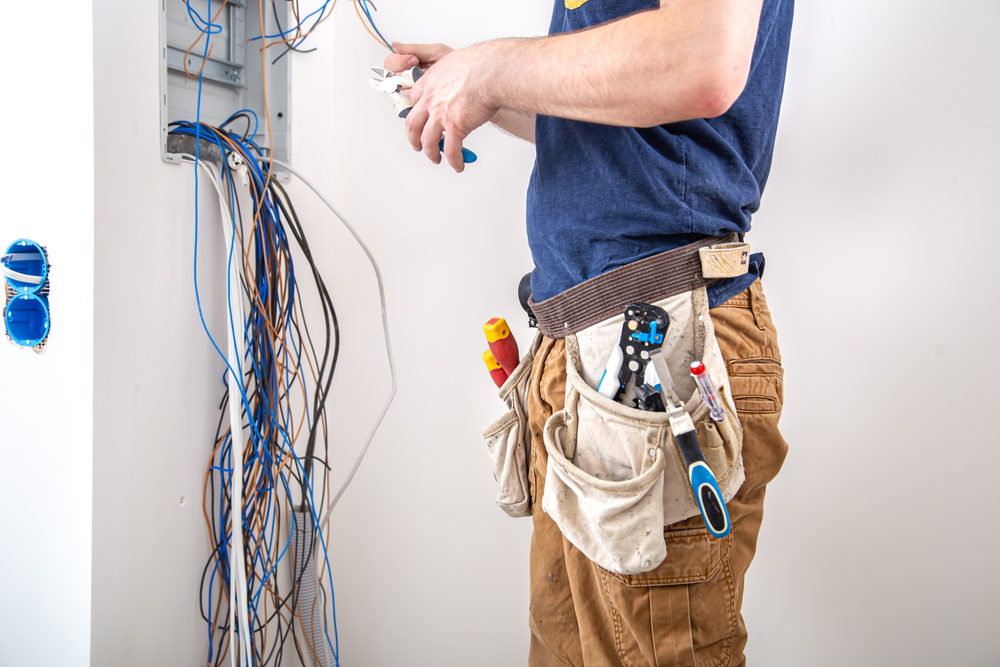 Electrician,Builder,At,Work,,Examines,The,Cable,Connection,In,The